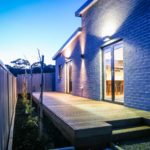Residential electrician installs deck lighting